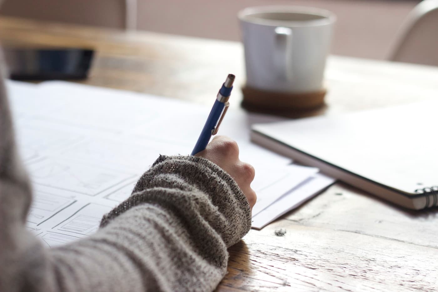 Notebook and study materials on a wooden desk